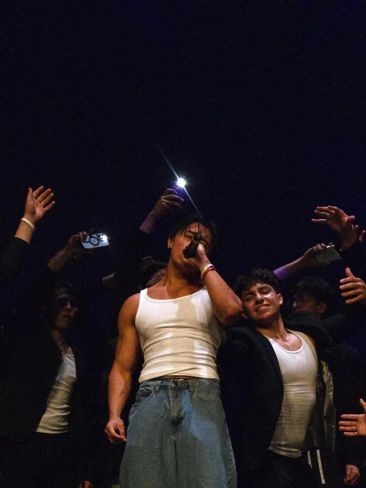 BROTHERS AND FRIENDS CELEBRATING AT A LIVE EVENT.